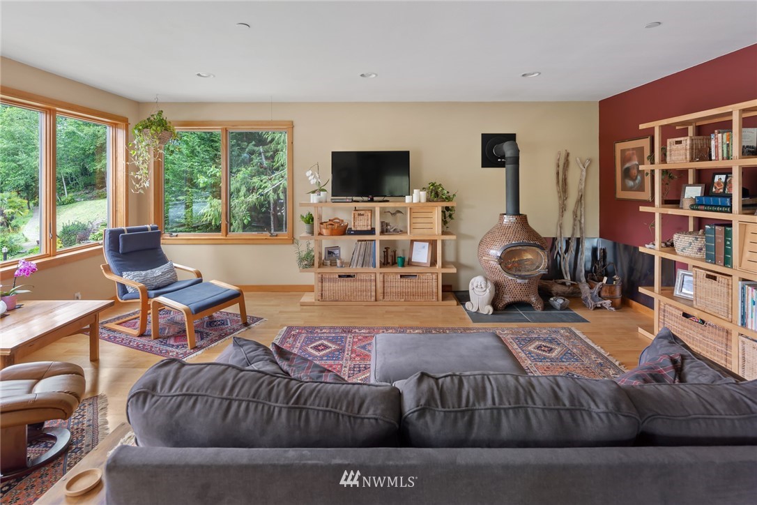 5909 Crescent Beach Road Northwest Vaughn, WA 98394 - Photo 15 of 35 a living room with furniture and a flat screen tv