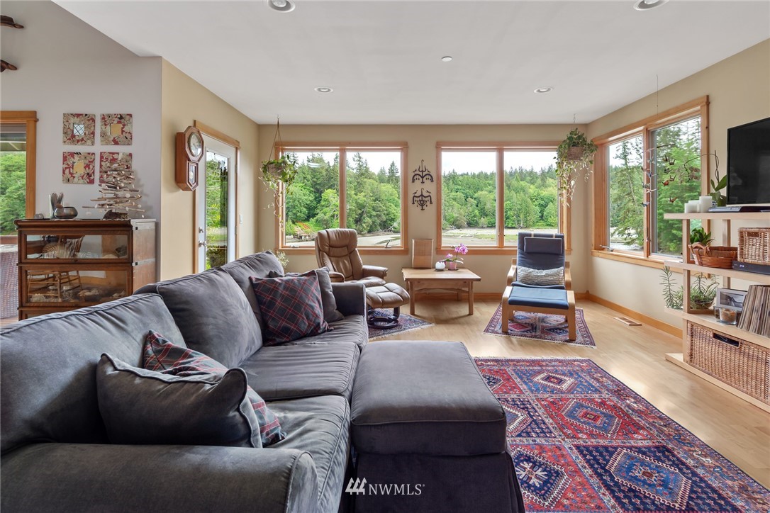 5909 Crescent Beach Road Northwest Vaughn, WA 98394 - Photo 16 of 35 a living room with furniture and large windows