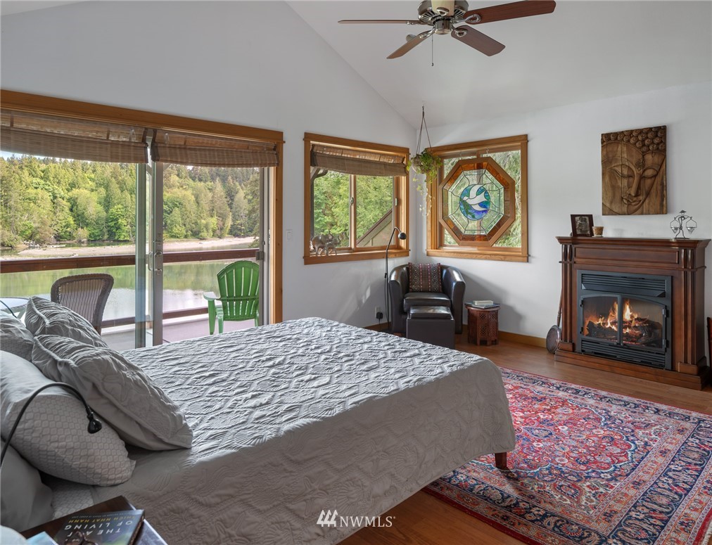 5909 Crescent Beach Road Northwest Vaughn, WA 98394 - Photo 18 of 35 a bed sitting in a bedroom next to a window