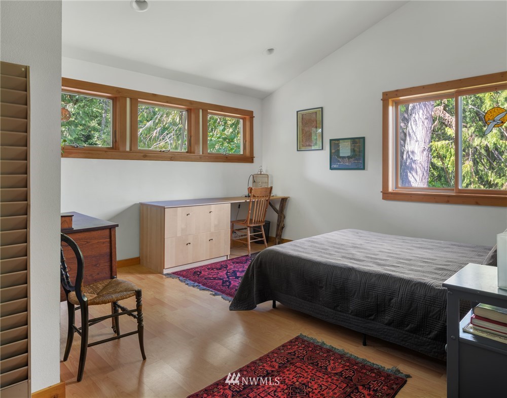 5909 Crescent Beach Road Northwest Vaughn, WA 98394 - Photo 21 of 35 a bedroom with a bed and a window