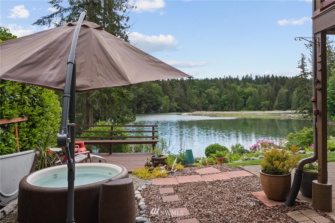 5909 Crescent Beach Road Northwest Vaughn, WA 98394 - Photo 27 of 35 a view of a table and chairs under an umbrella