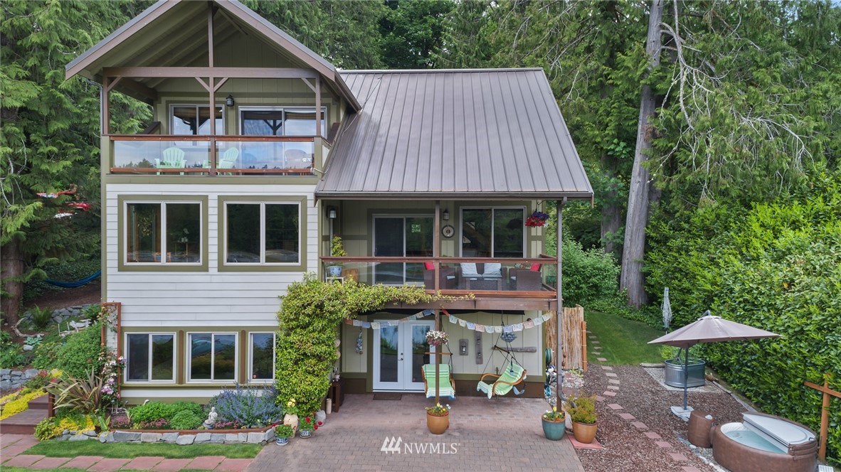 5909 Crescent Beach Road Northwest Vaughn, WA 98394 - Photo 31 of 35 a front view of a house with garden