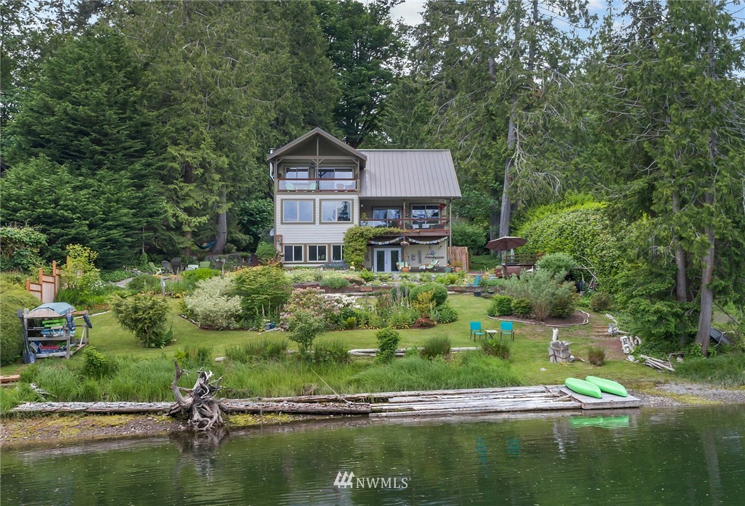5909 Crescent Beach Road Northwest Vaughn, WA 98394 - Photo 6 of 35 a house with river in front of it