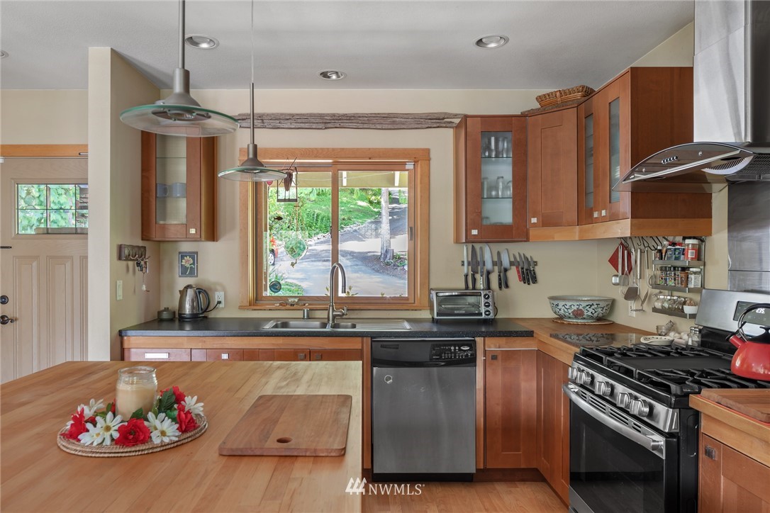 5909 Crescent Beach Road Northwest Vaughn, WA 98394 - Photo 10 of 35 a kitchen with stainless steel appliances granite countertop a stove and a sink