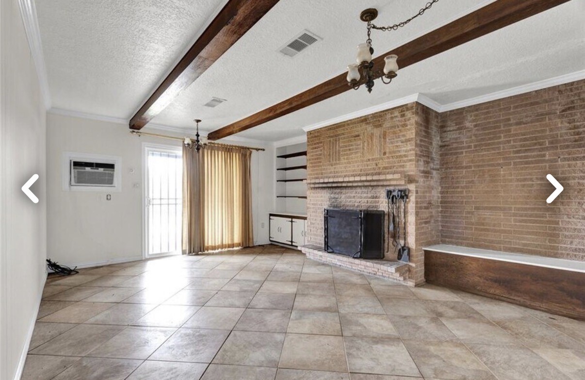 6009 Maple Street Houston, TX 77074 - Photo 6 of 11 a view of a livingroom with a fireplace and window