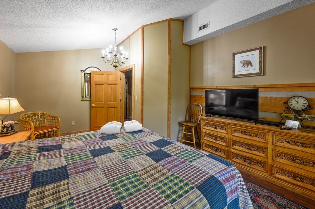 4296 Powdermill Estates Road Sevierville, TN 37876 - Photo 29 of 55 a bedroom with a bed and wooden floor