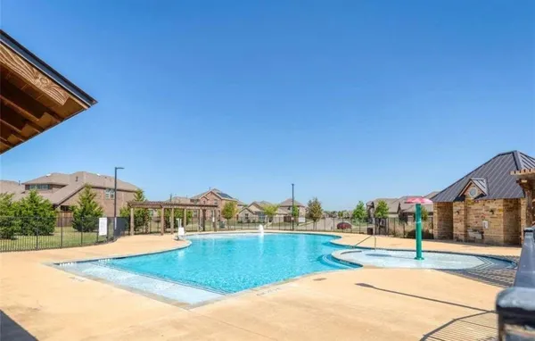 a view of a swimming pool with an outdoor seating
