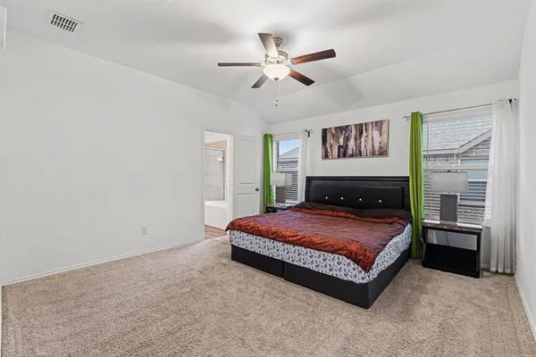 a bedroom with a bed and dresser