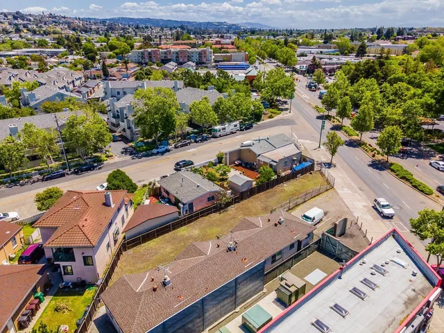 an aerial view of residential houses with outdoor space