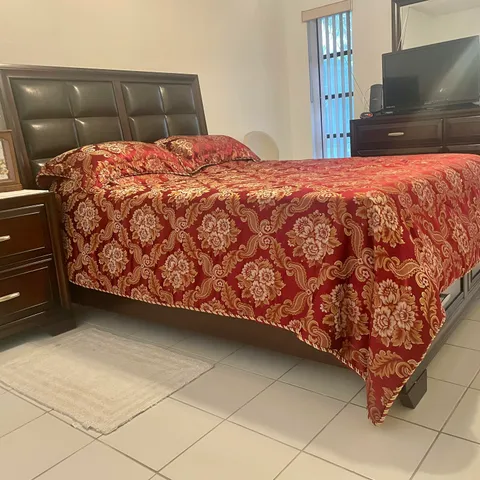 a bedroom with a bed and a television