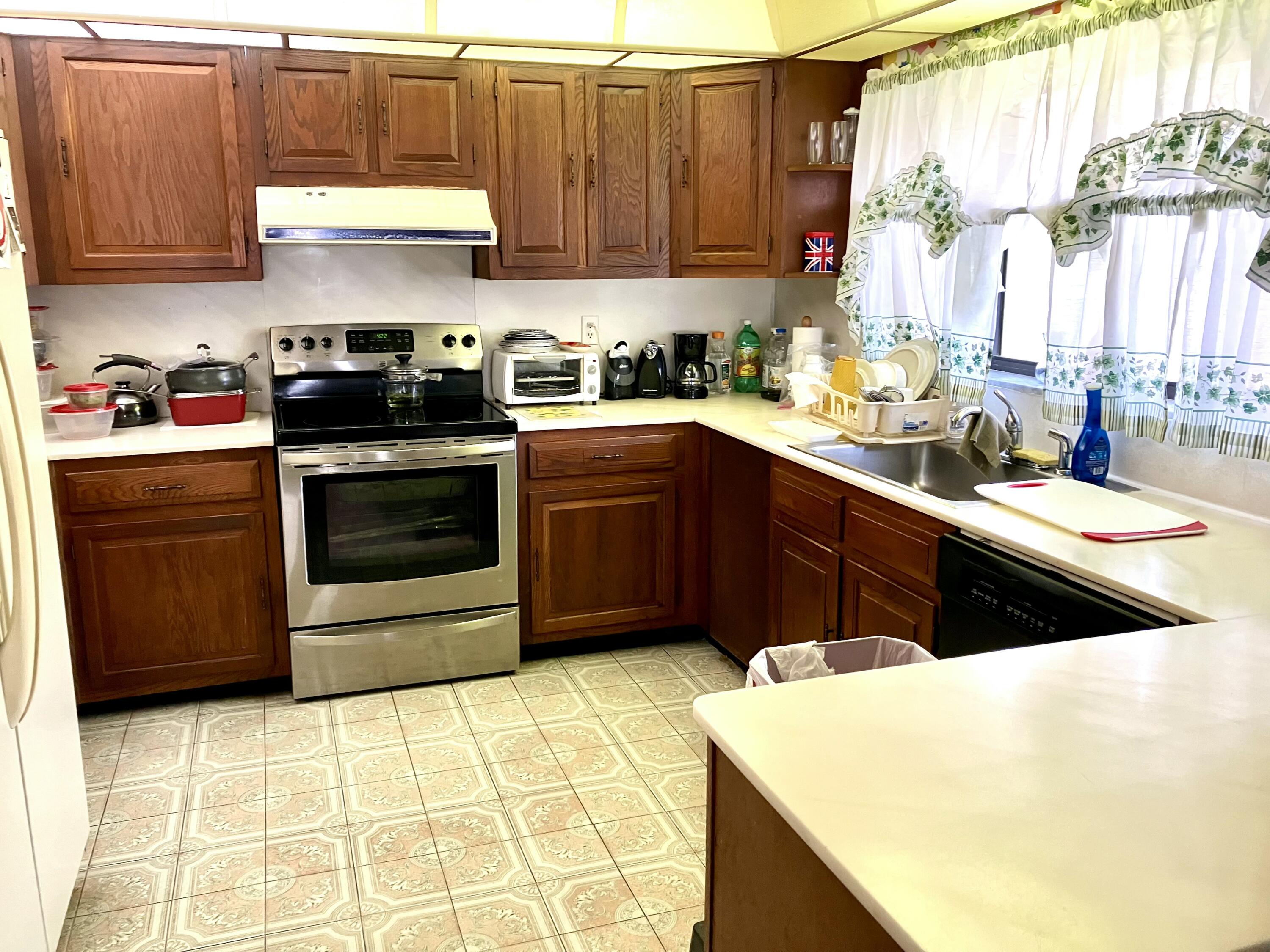 Undisclosed Address Royal Palm Beach, FL 33411 - Photo 5 of 5 a kitchen with a sink stove and cabinets
