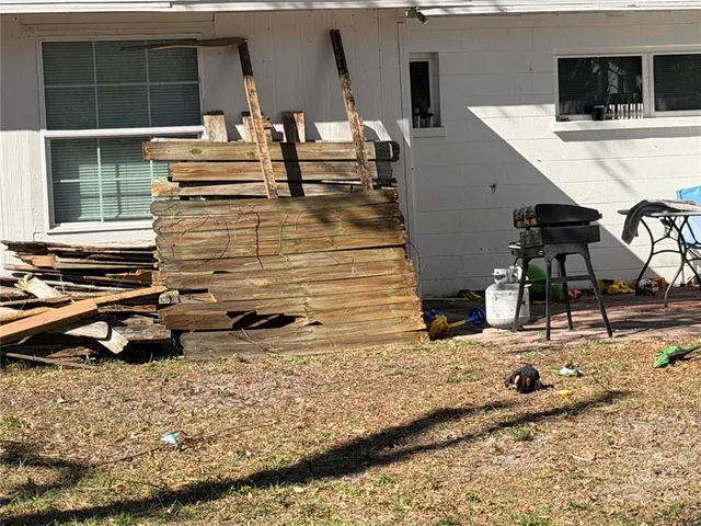 a backyard of a house with table and chairs