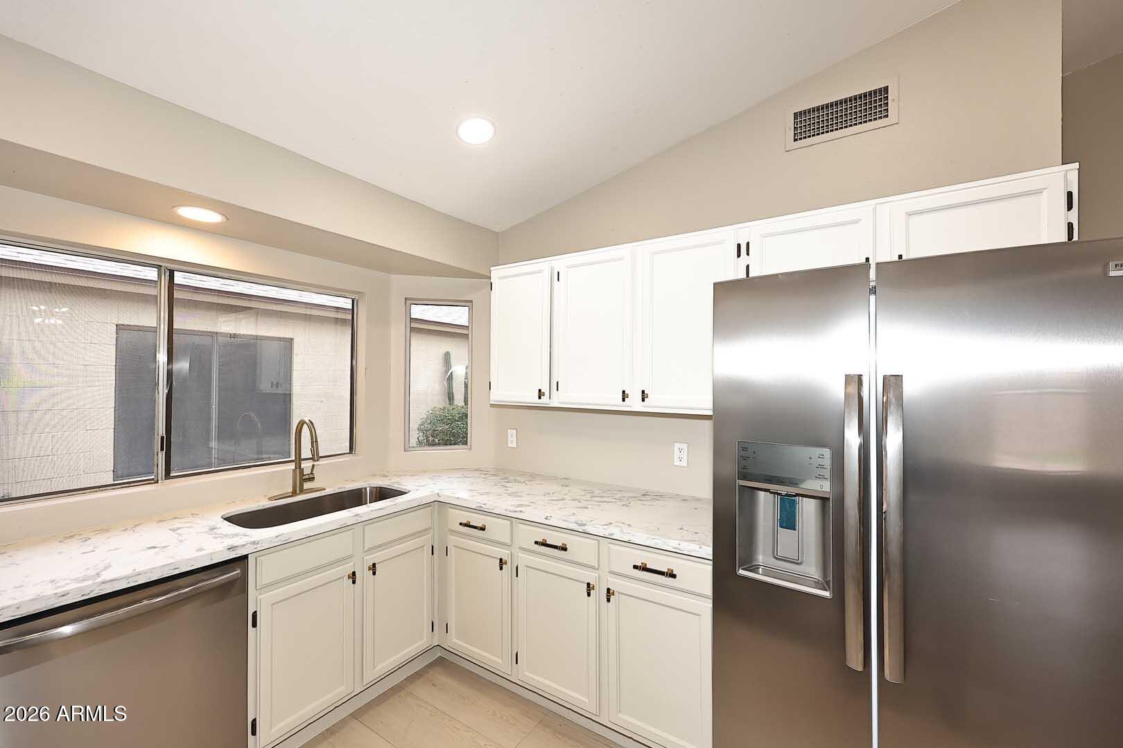 10844 West Ruth Avenue Peoria, AZ 85345 - Photo 13 of 33 a kitchen with stainless steel appliances granite countertop a refrigerator and a sink