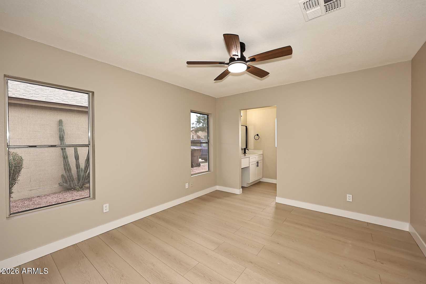 10844 West Ruth Avenue Peoria, AZ 85345 - Photo 23 of 33 a view of a big room with wooden floor and windows
