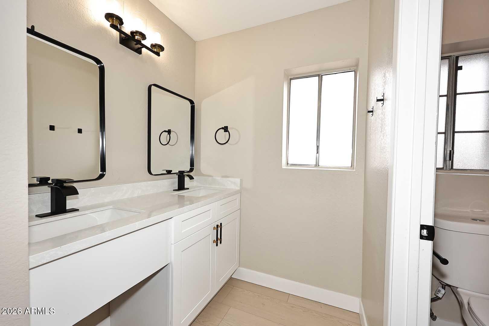 10844 West Ruth Avenue Peoria, AZ 85345 - Photo 25 of 33 a bathroom with double vanity sink and a mirror