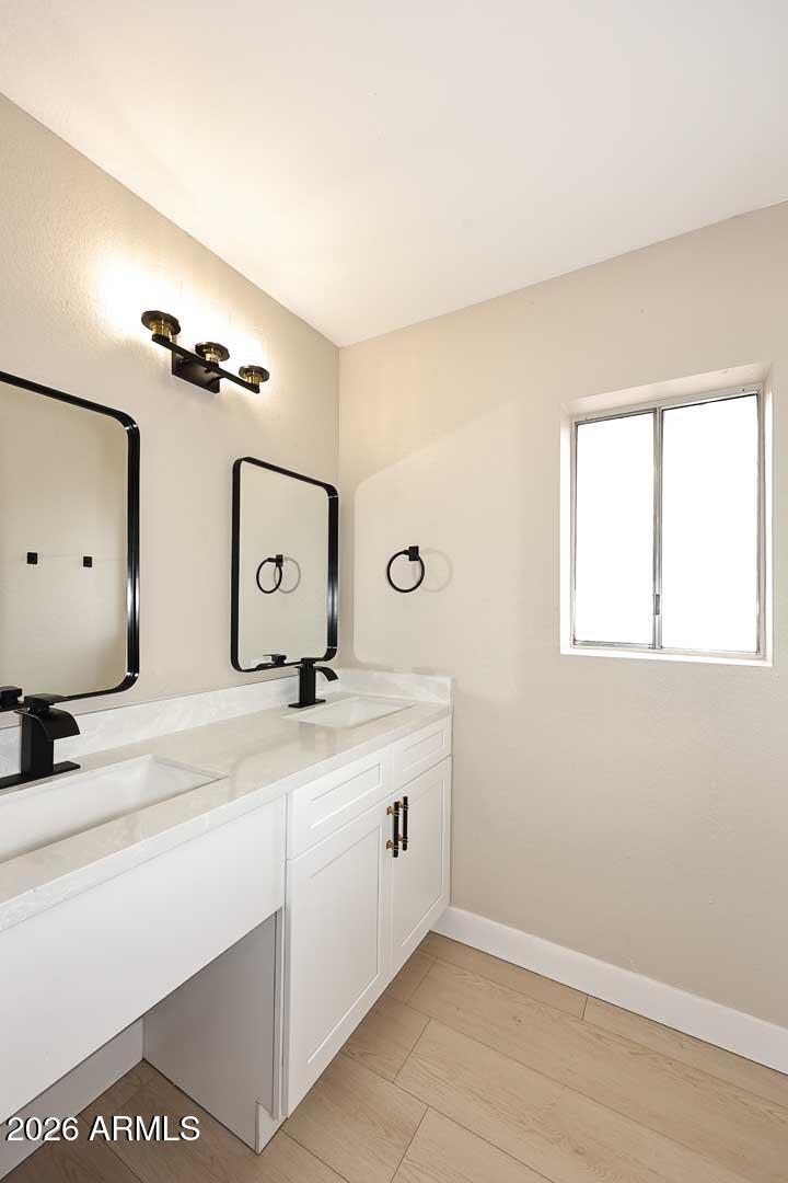 10844 West Ruth Avenue Peoria, AZ 85345 - Photo 26 of 33 a bathroom with a double vanity sink and a mirror