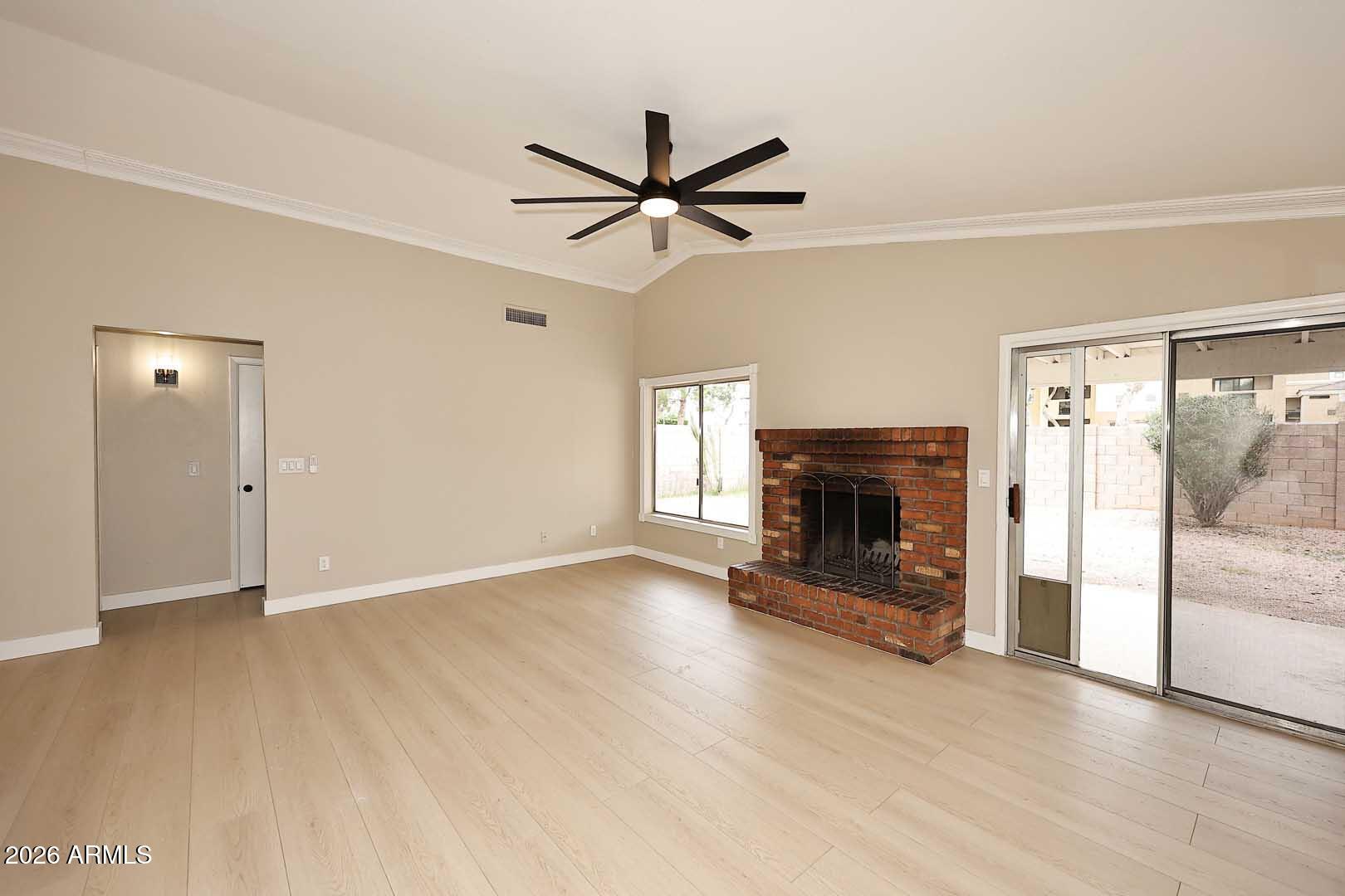10844 West Ruth Avenue Peoria, AZ 85345 - Photo 5 of 33 a view of a livingroom with a fireplace and window