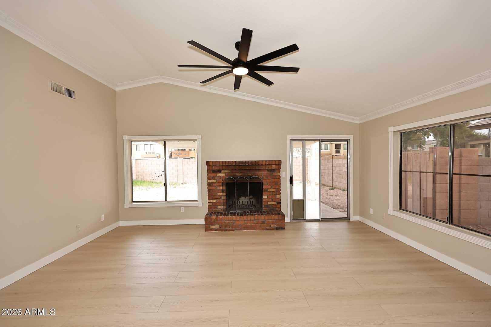 10844 West Ruth Avenue Peoria, AZ 85345 - Photo 6 of 33 a view of an empty room with a fireplace and a window