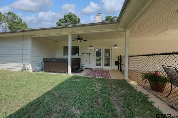 a living room with furniture a flat screen tv and kitchen view