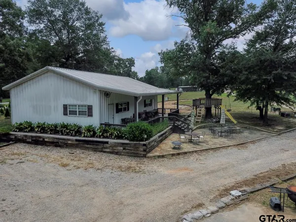 a view of a house with a yard covered in snow