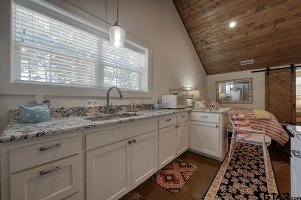 a living room with furniture flat screen tv and a large window