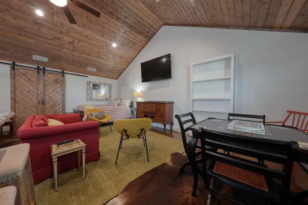 a living room with furniture a chandelier a rug and a window