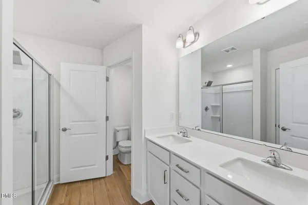 a bathroom with a shower and a glass door