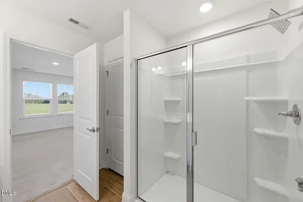 a bathroom with a shower sink vanity granite and shower