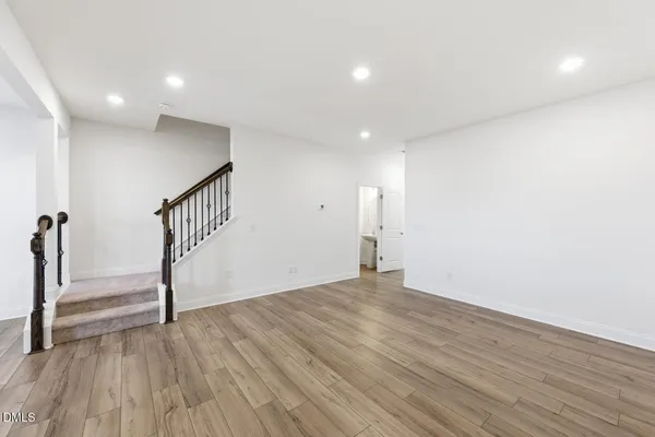 a large kitchen with stainless steel appliances a large counter top and a wooden floors