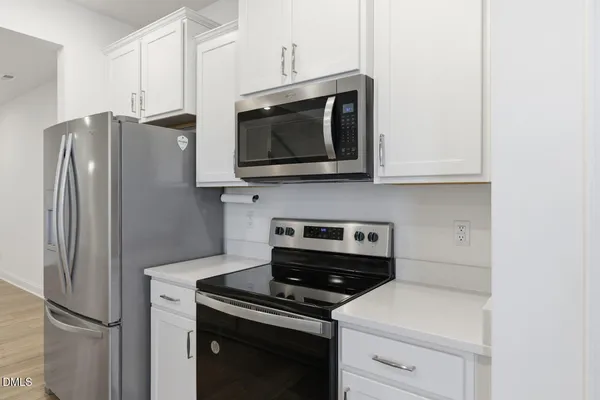 a kitchen with a sink and a refrigerator