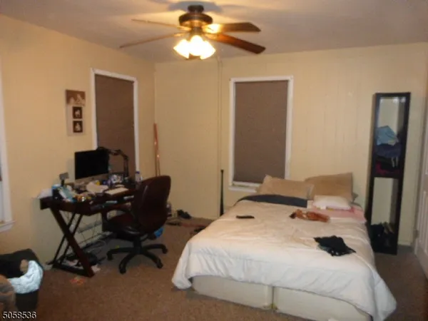 a bedroom that has a bed and a desk