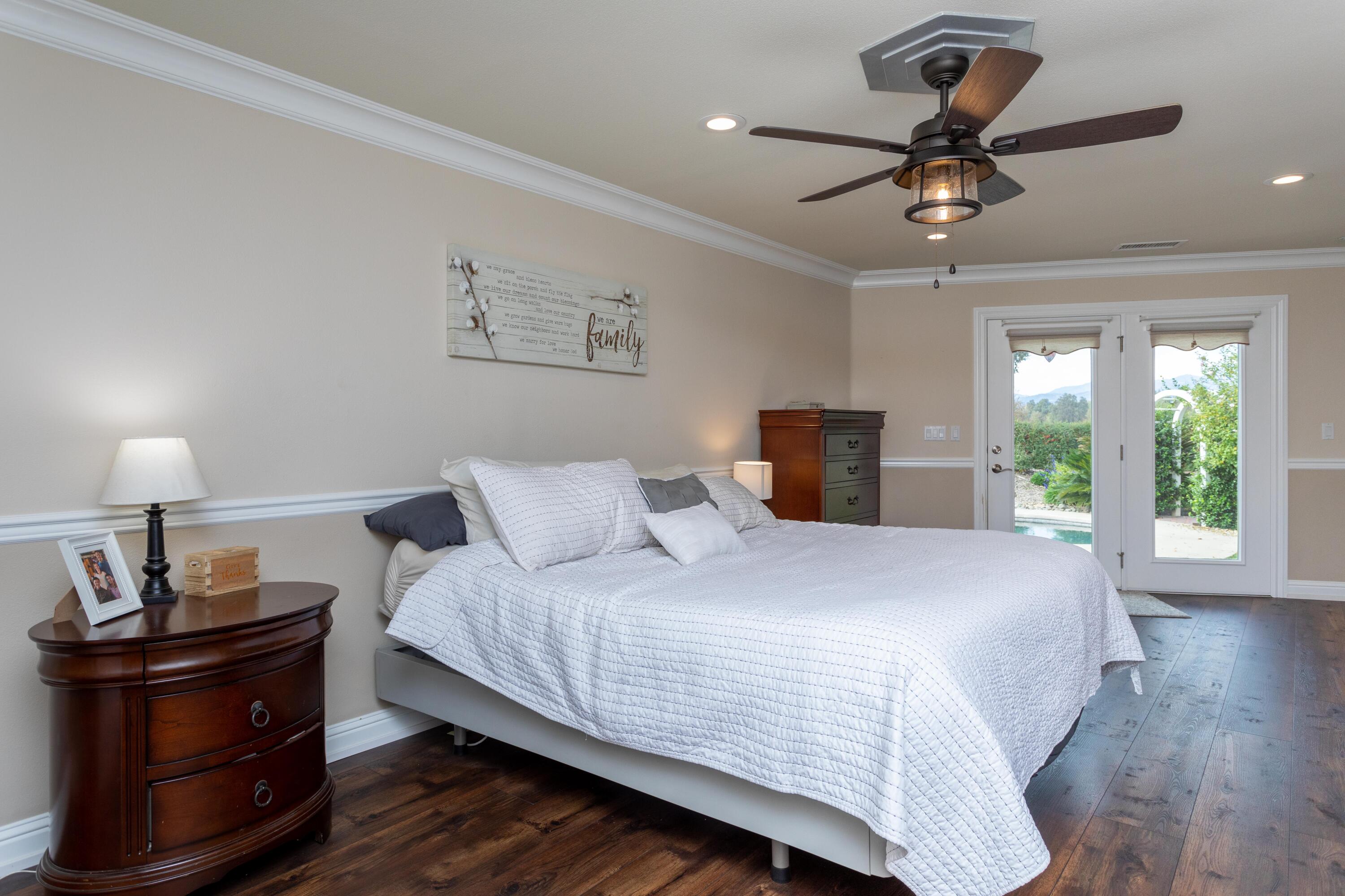 5956 Riverside Drive Redding, CA 96001 - Photo 25 of 54 a bedroom with a bed and wooden floor