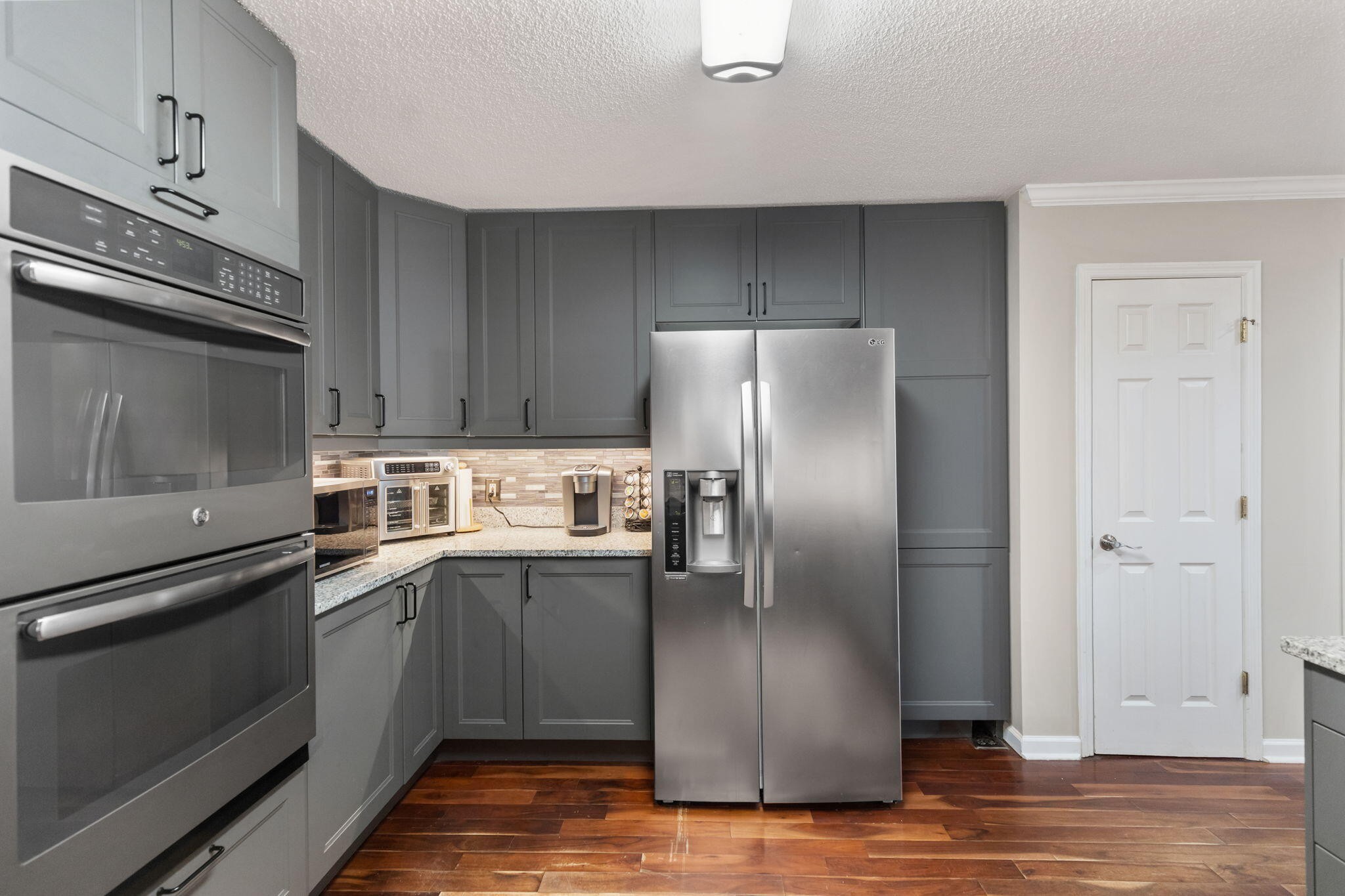 2415 Yellowood Court Cleveland, TN 37312 - Photo 19 of 83 a kitchen with stainless steel appliances granite countertop a refrigerator a stove and a sink with wooden floor