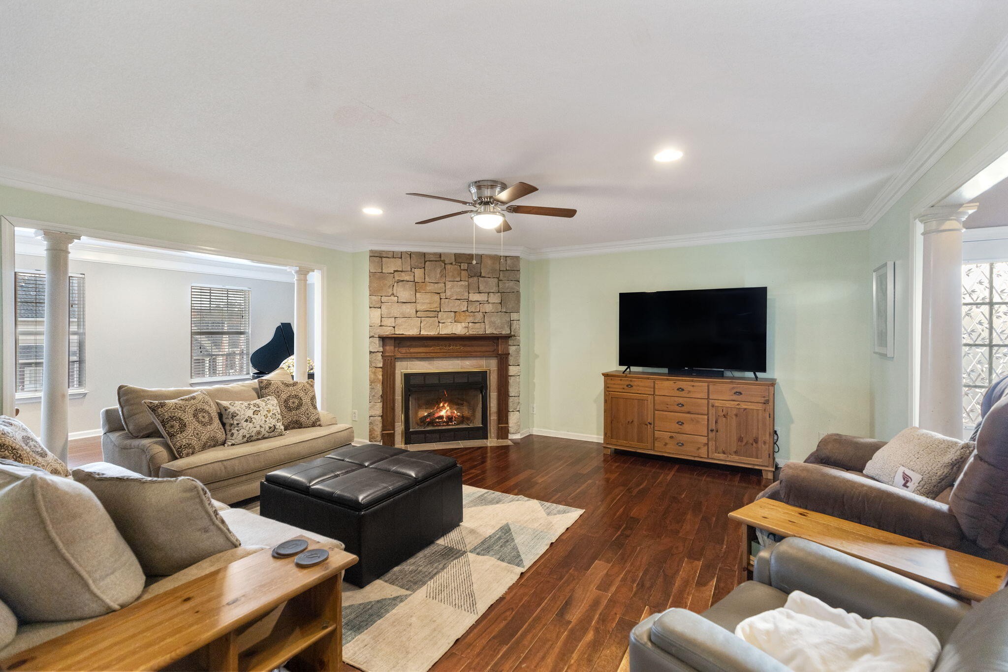 2415 Yellowood Court Cleveland, TN 37312 - Photo 20 of 83 a living room with furniture a flat screen tv and a fireplace