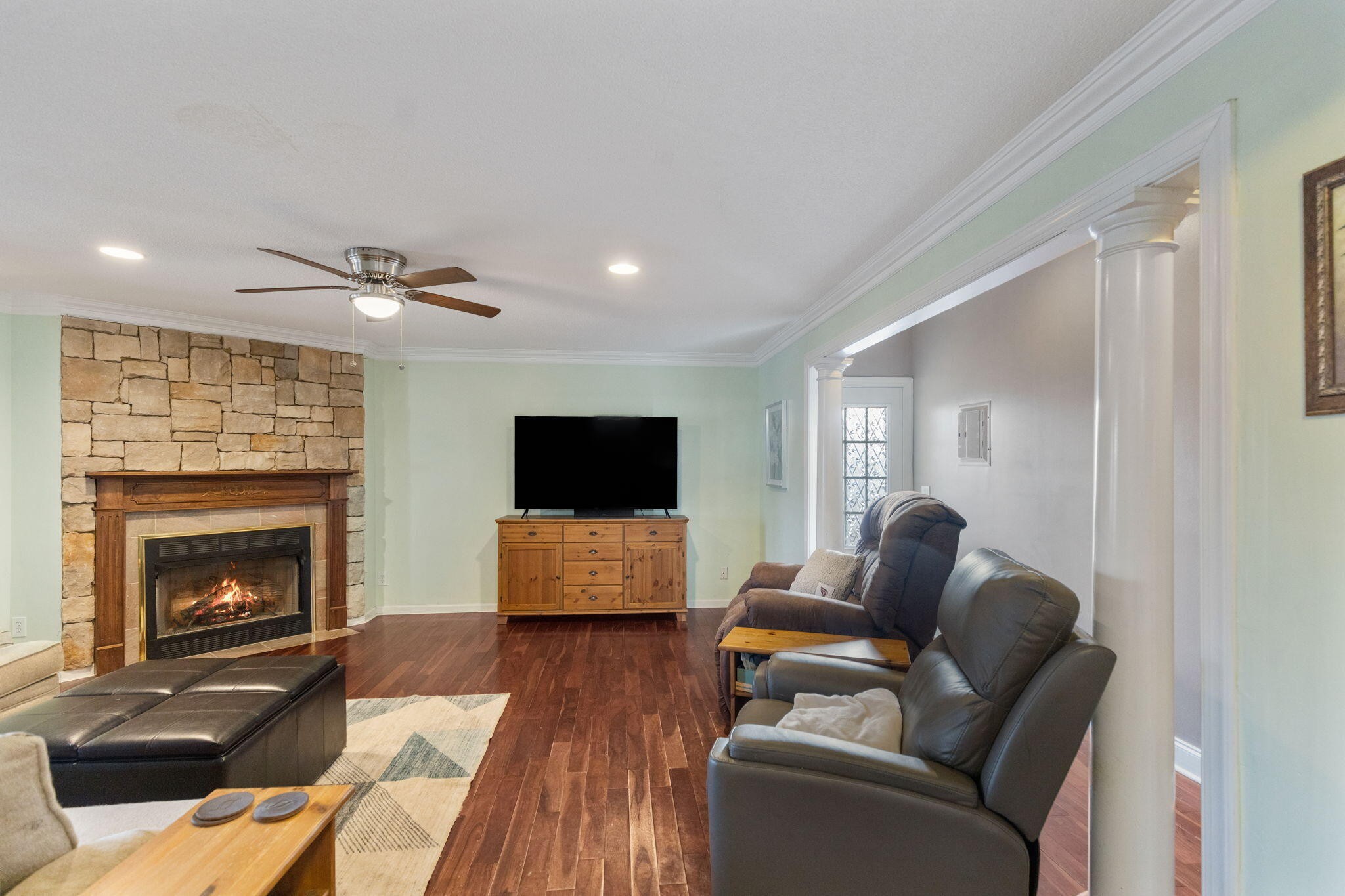 2415 Yellowood Court Cleveland, TN 37312 - Photo 21 of 83 a living room with furniture a flat screen tv and a fireplace