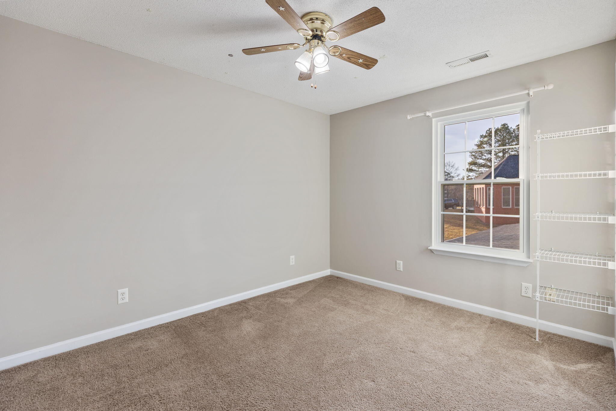 2415 Yellowood Court Cleveland, TN 37312 - Photo 46 of 83 an empty room with a window and a fan