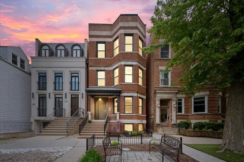a front view of a residential apartment building with a yard