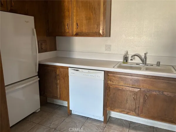 a kitchen with a sink and a refrigerator