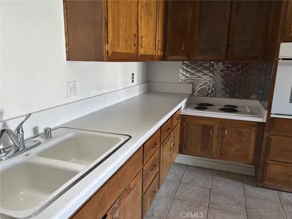 a kitchen with a sink and a stove top oven