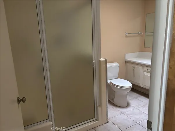 a white toilet sitting next to a bathroom sink
