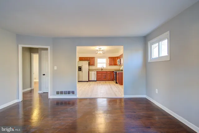 a view of a livingroom with wooden floor and a window