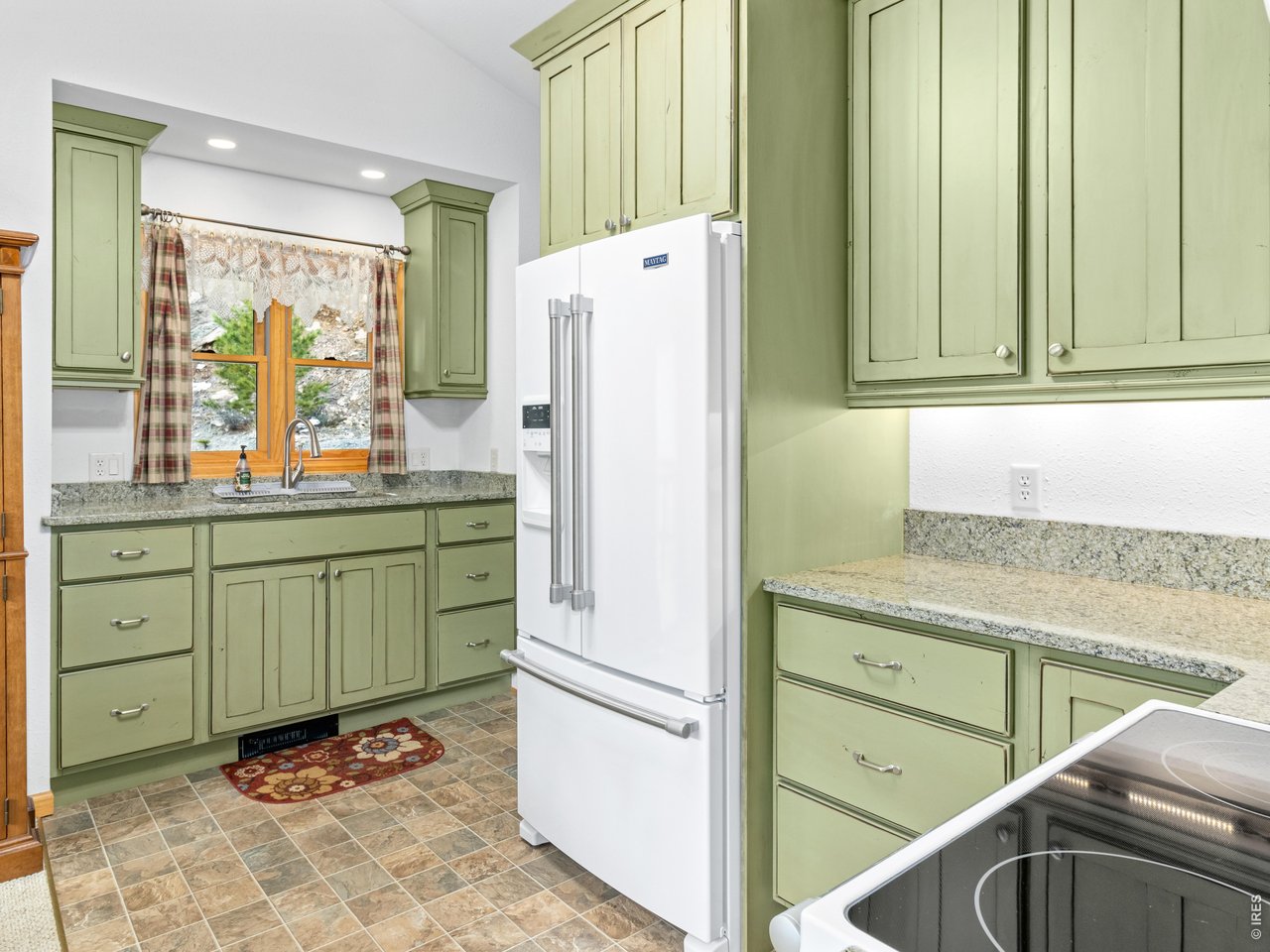 1002 Streamside Drive Drake, CO 80515 - Photo 21 of 37 a kitchen with a refrigerator and a sink