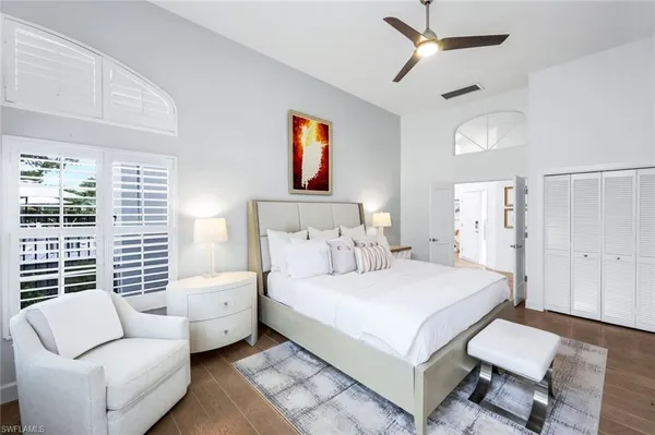 a bedroom with a bed couch and a window