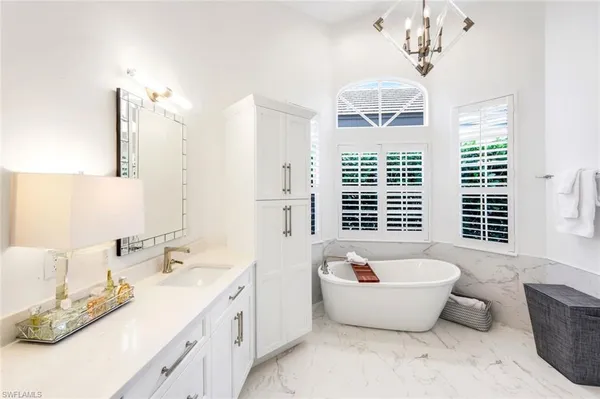 a spacious bathroom with a granite countertop sink and a large mirror