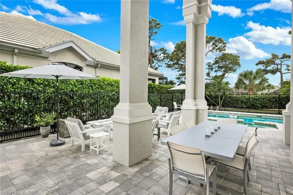 a view of a patio with table and chairs and potted plants