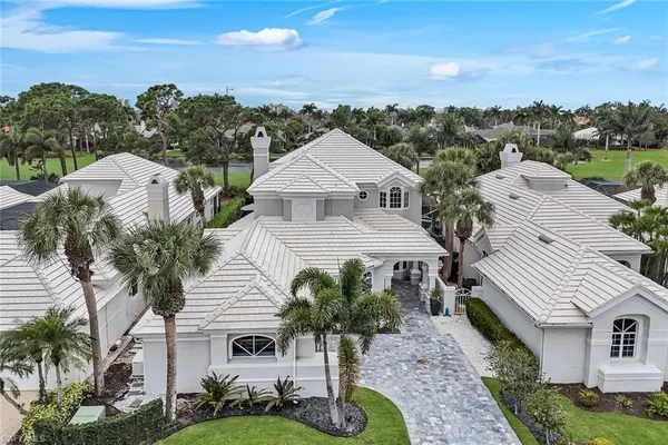 an aerial view of a house with garden space and street view