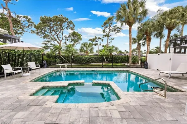 a view of a swimming pool with a lounge chair