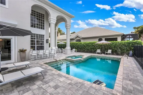 a view of swimming pool with outdoor seating and a potted plant