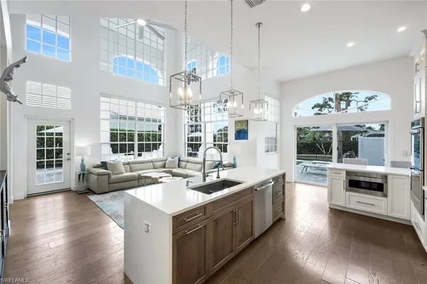 a large kitchen with a large counter top appliances and cabinets
