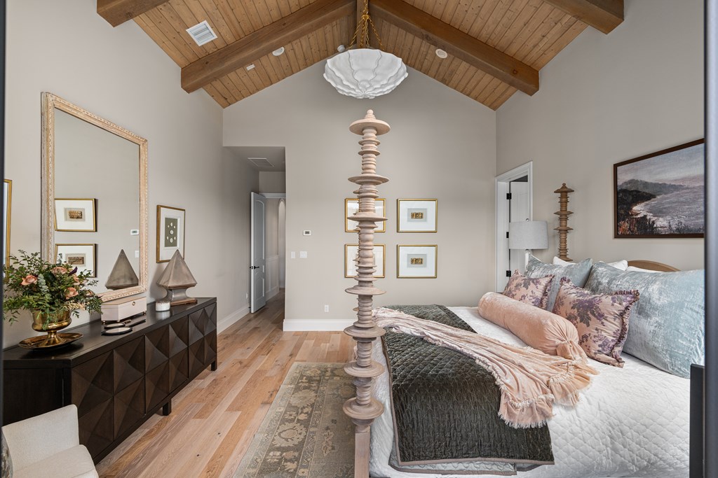 4412 Comanche Trace Drive Kerrville, TX 78028 - Photo 26 of 46 a bedroom with a bed and a chandelier